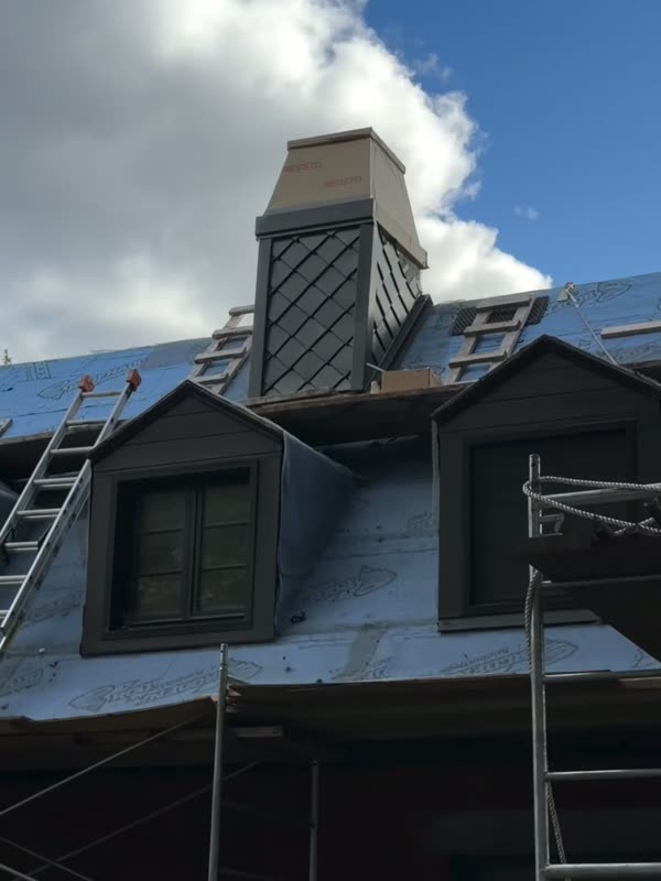 Chimney with diamond scale detail on a slate roof